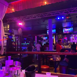 people at a bar with neon lights