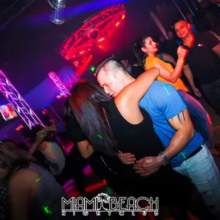 a man and a woman dancing at a nightclub