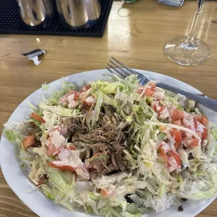 Forgot the name but it was pulled pork with black beans and rice and then you had kinda like salad on top with the sauce.