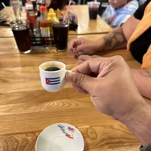 a hand holding a cup of coffee