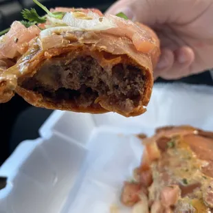 a hand holding a piece of food