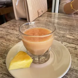 Lemon and ginger shot with pineapple on the side