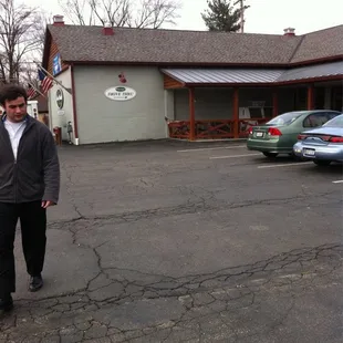 a man walking in a parking lot