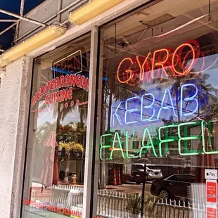 a neon sign in the window