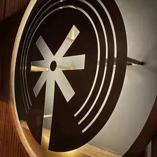 a circular clock with a black and white design