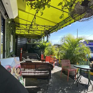 a patio with tables and chairs