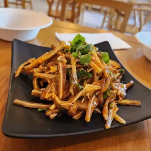 a plate of noodles and dumplings