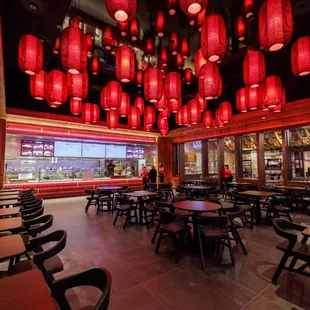 a restaurant with red lanterns hanging from the ceiling
