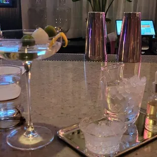 a bar with glasses and flowers