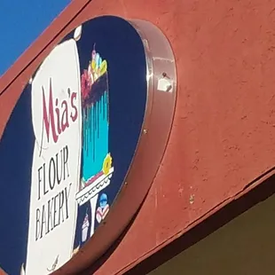 a circular sign on the side of a building