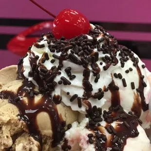 Three Maria's is a Waffle Bowl with three different flavors of ice cream, with whipped cream and a cherry on top.