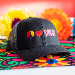 a black hat with a peace sign on it