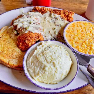 Chicken Fried Chicken Platter covered in jalapeño gravy with Creamed Corn and Mashed Potatoes