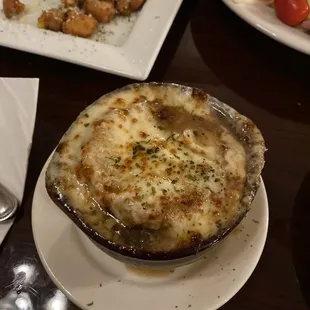 French onion soup and some Cheese curds in the background
