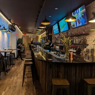 a restaurant with a bar and a television