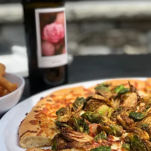 Bacon and Brussels sprout pizza, truffle fries and rose wine.
