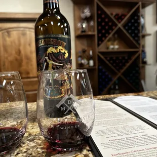 a bottle of wine and two glasses of wine