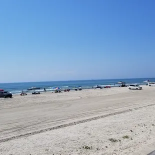 Cars and canopies on beach