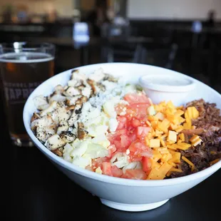 a bowl of food and a pint of beer