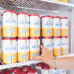 a person reaching for a can of mountain dew