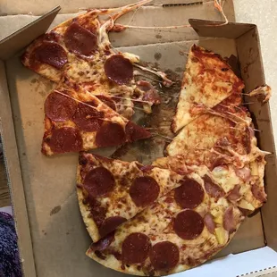 a half eaten pepperoni pizza