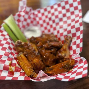 a basket of wings and celery
