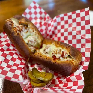 a hot dog with cheese and pickles
