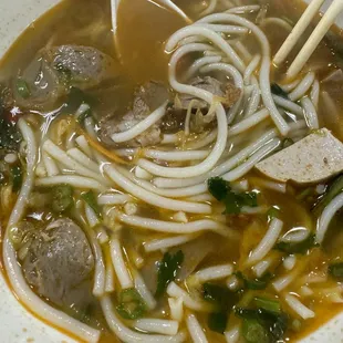Half eaten spicy beef noodle soup.