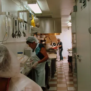two women in a kitchen preparing food