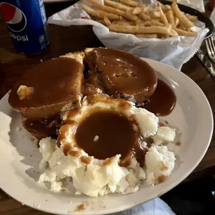 Hot prime rib sandwich with mashed potatoes and gravy, side of fries