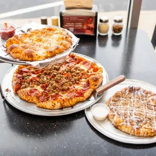 two pizzas on a table