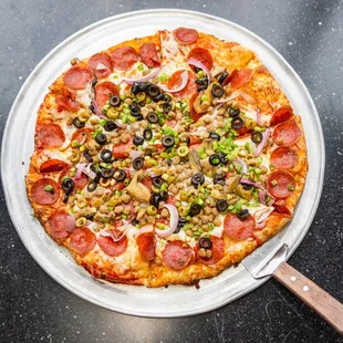 a pizza with pepperoni and olives