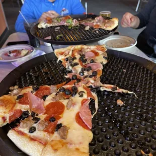 two men eating pizza