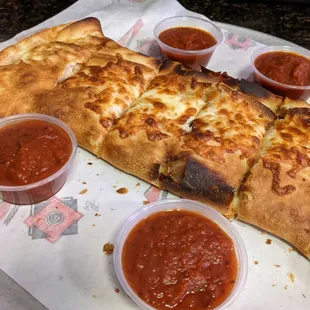 Large calzones with tons of marinara sauce