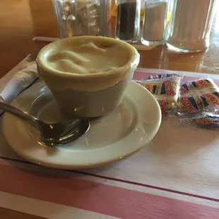 a cup of cappuccino and a spoon