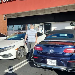 a car parked in front of a sports pub and grill