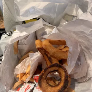 Under cooked fries and onion rings(yet burned) of a 2 burger special and this is all that was in the bag. Disappointed after 15 years