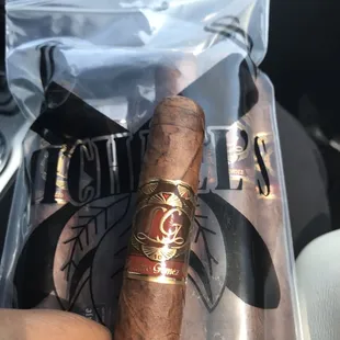 a hand holding a cigar