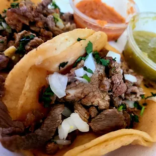 Carne aside tacos with red and green salsa