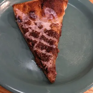 a slice of pizza on a plate