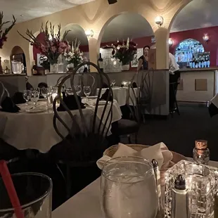 Interior of restaurant is very inviting with white table cloth service.