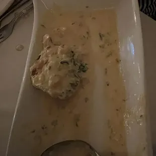 One of four oysters Rockefeller, one of four large oysters.