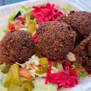 Falafel with a scoop of Cilantro Hummus, original hummus, and Chipotle Hummus.