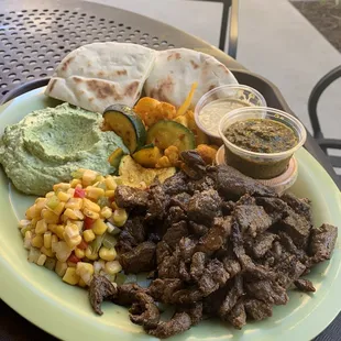 Steak Combo Plate with cilantro hummus, corn salad, and roasted veggies.