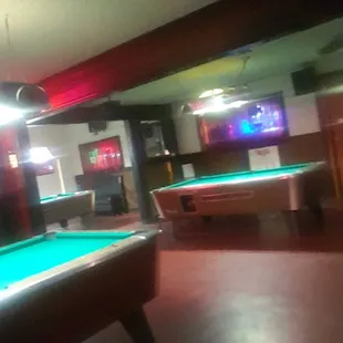 two pool tables and a television