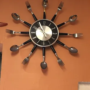 a clock made out of forks and spoons