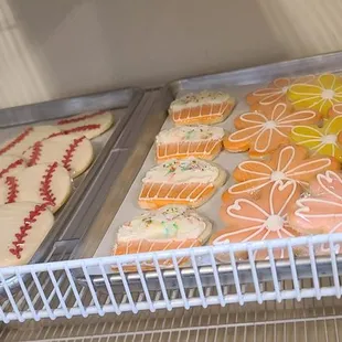 a variety of decorated cookies in a refrigerator