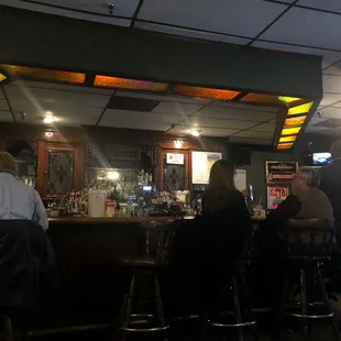 a group of people sitting at a bar