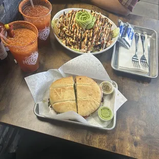 Torta de pastor and ceviche nachos accompanied with michelada de mango y tradicional.