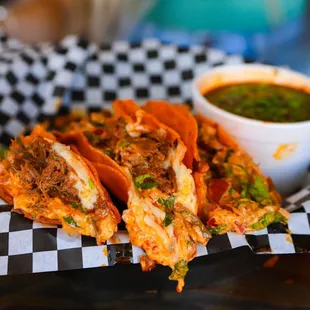 a plate of tacos and a bowl of salsa